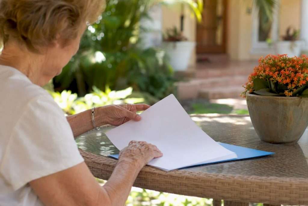 Senior hands preparing reverse mortgage documents